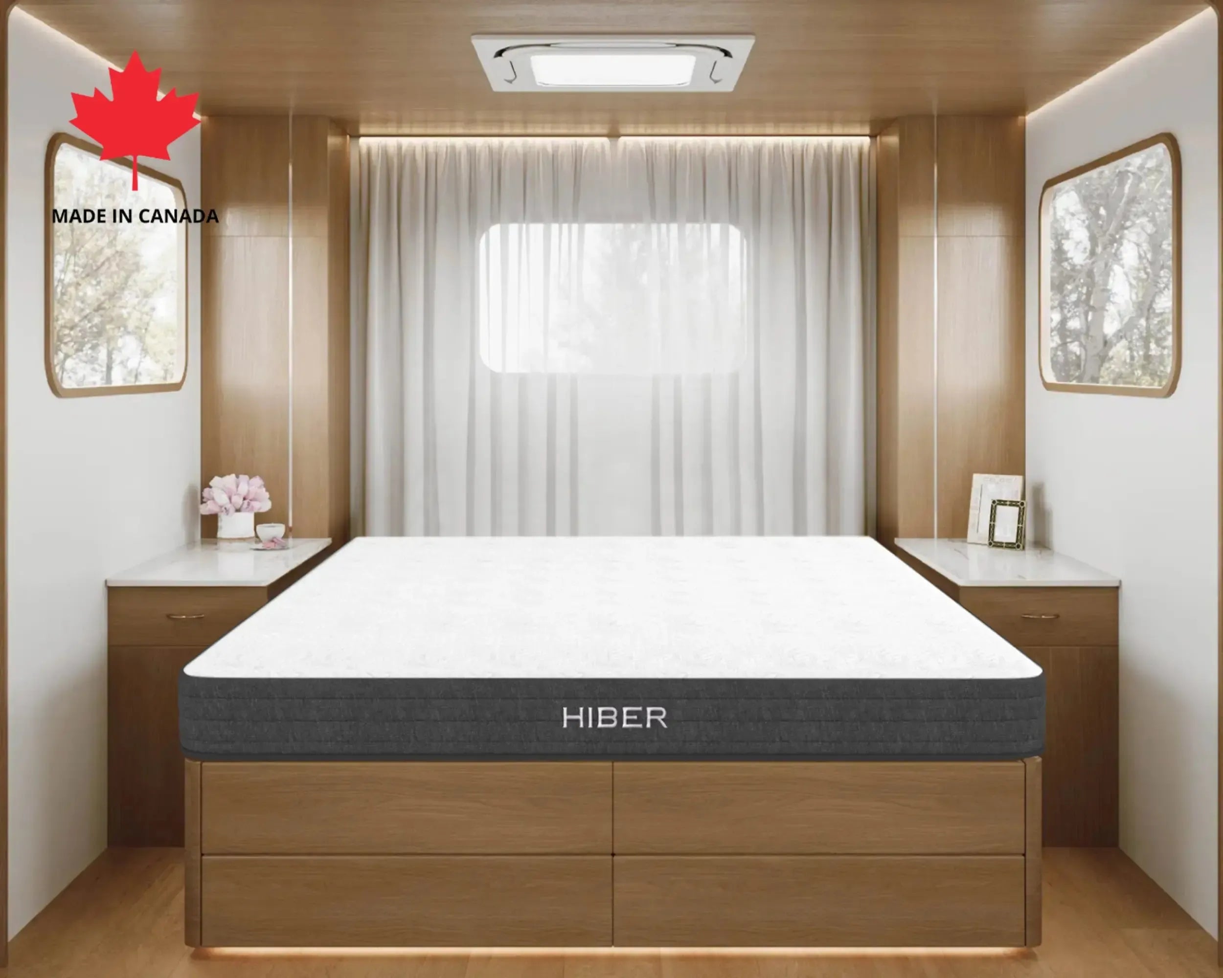 Hiber mattress in a modern bedroom setting with wooden furniture and a window.