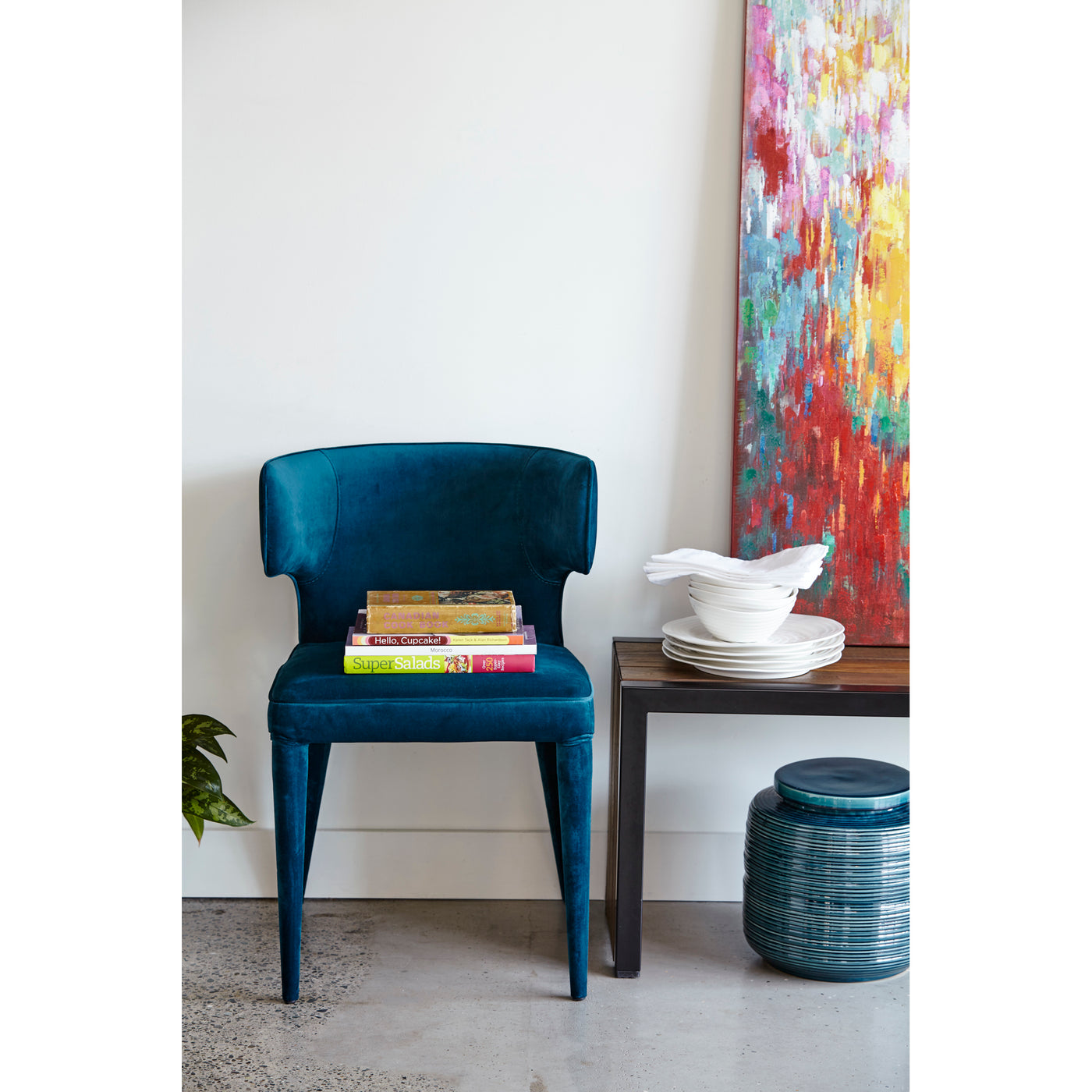 With an elegant, hourglass figure and a stunning teal, polyester-velvet upholstery, this is the perfect chair to add a pun...