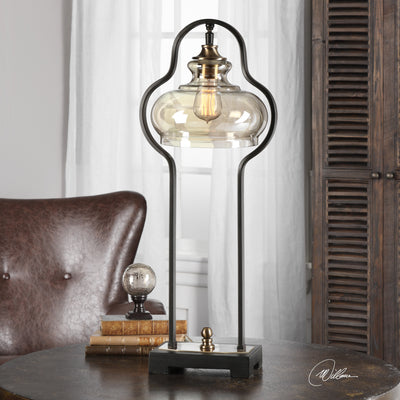 Curvaceous Forged Iron Finished In An Aged Black, Following The Contour Of The Light Amber Glass Shade, Accented With Brus...