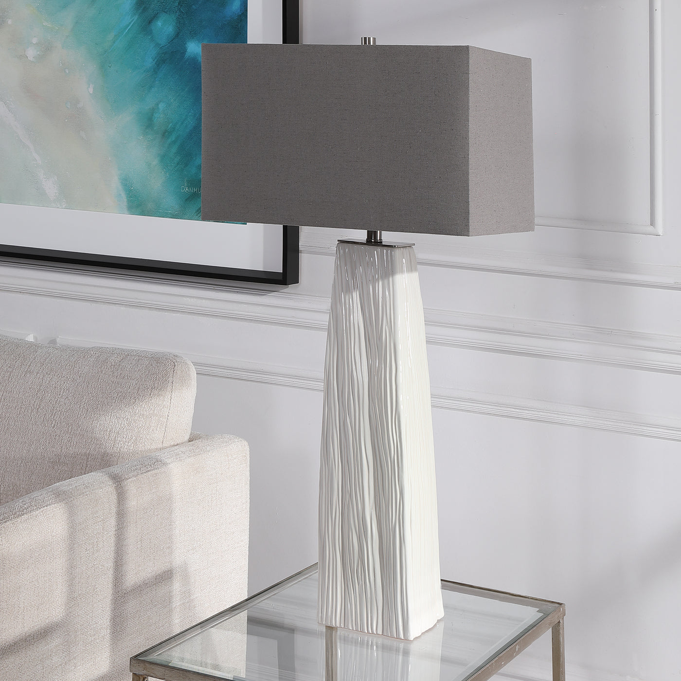 Elegant And Versatile, This Table Lamp Features A Gloss White Ceramic Base Featuring Organic Hand Carved Details And Brush...
