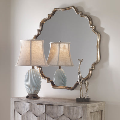 This Shapely Mirror Features A Frame With A Plated, Oxidized Silver Finish And A Rust Gray Wash.