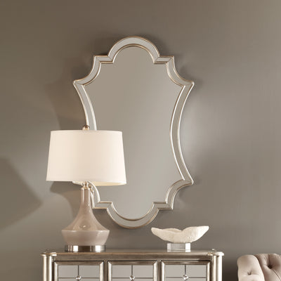 Gracefully Curved Polished Edged Mirror Facets Encased In A Lightly Antiqued Silver Leafed Frame.