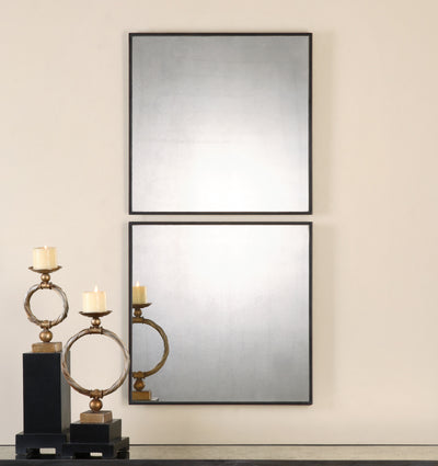 Antiqued Mirrors Accented With Aged Black Frames With Red Undertones.