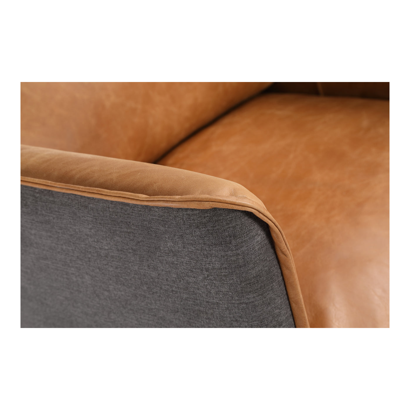The Messina is a cozy lounge chair that your guests will want to sit in for hours. Short iron legs boast mid-century desig...