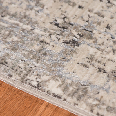 This Power Loomed Rug Features An Abstract Design In Tones Of Polyester Charcoal, Ivory, Light Gray, And Silver.