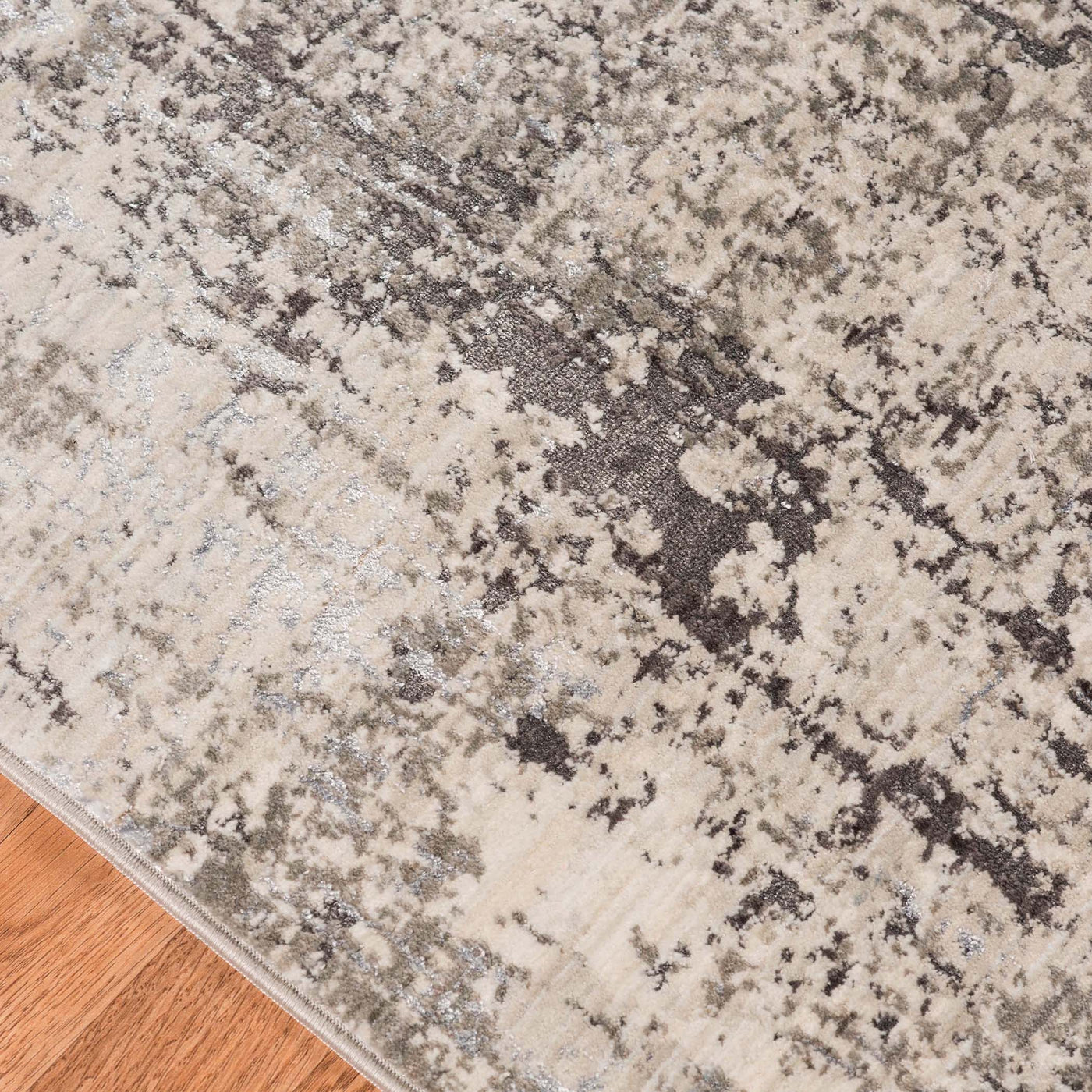 This Power Loomed Rug Features An Abstract Design In Tones Of Polyester Charcoal, Ivory, Light Gray, And Silver.
